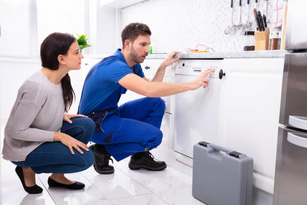 Technician repairing a dishwasher