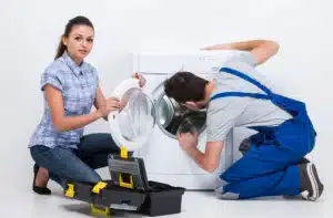 a men and women are repair washing maching